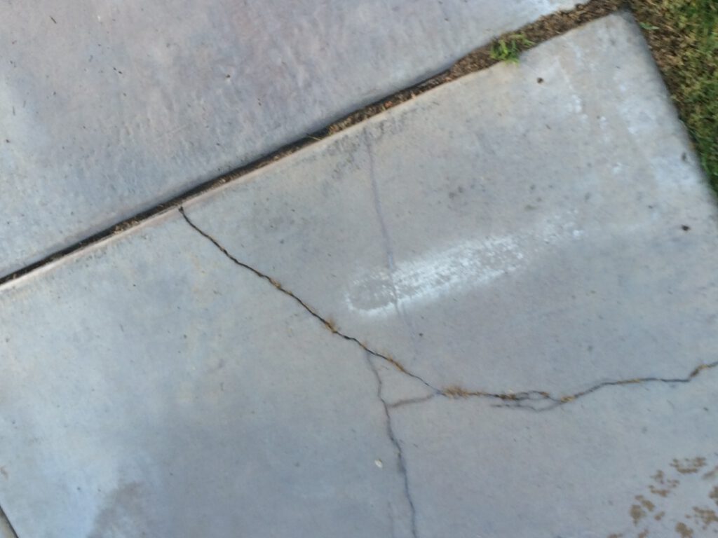 Sidewalk in need of repair by City