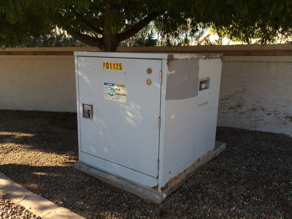 SRP Electrical Box at West end of Carver. Box rusting and needs painting. Also, Common wall in need of power wash or painting