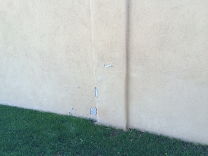 Wall damage - possibly by lawn mower?